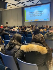 Roger speaks in front of a group of students