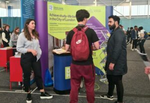 Konstantina and Hassan talking to students at the UCAS East London Exhibition