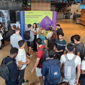 University exhibition stall with a crowd of students