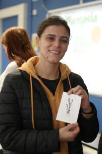 A student shows to the camera their linocut creation.