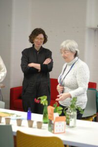 Patricia and Fiona work together in the gardening workshop table