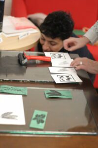 Roshi works on her linocut table setting